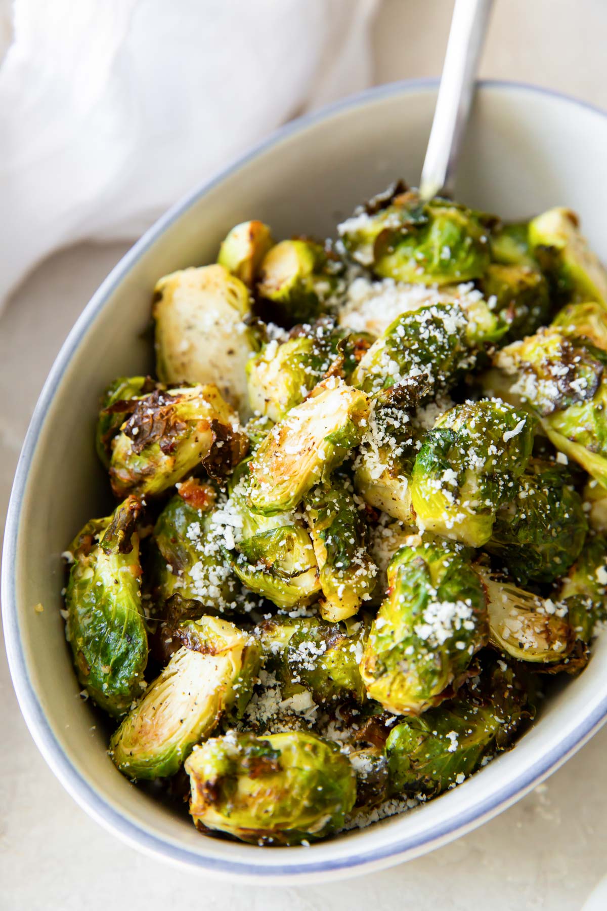 close up of brussels sprouts with parmesan in a serving dish
