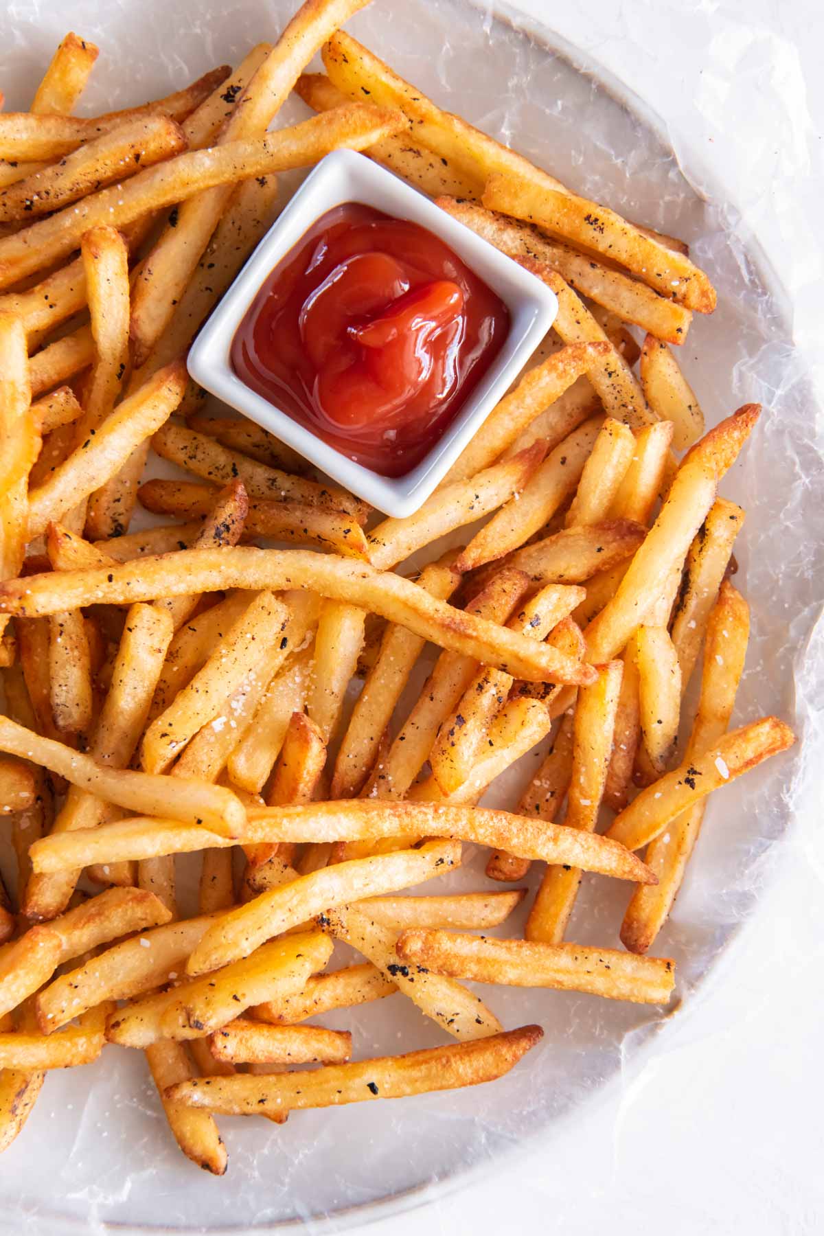 French fries served with small dish of ketchup.