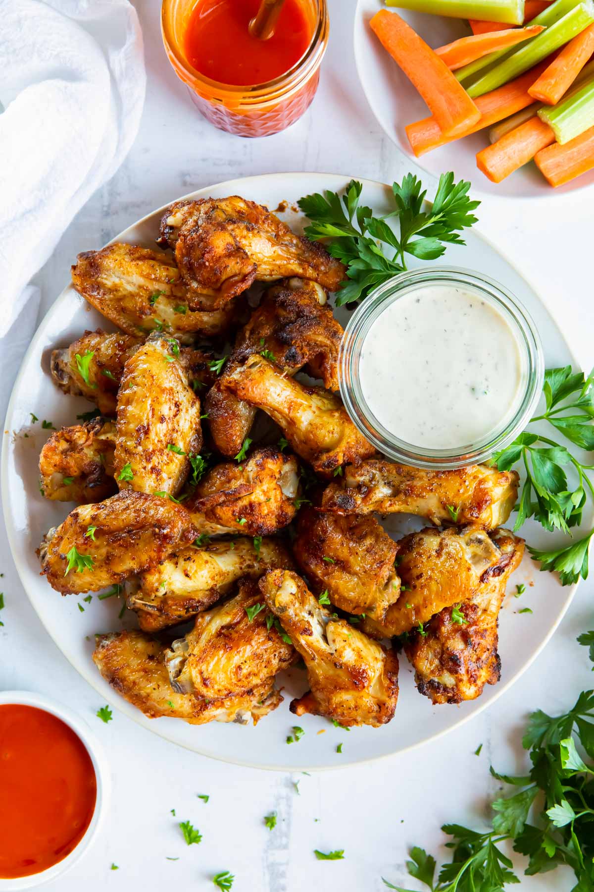 air fryer chicken wings served with ranch dressing and buffalo sauce