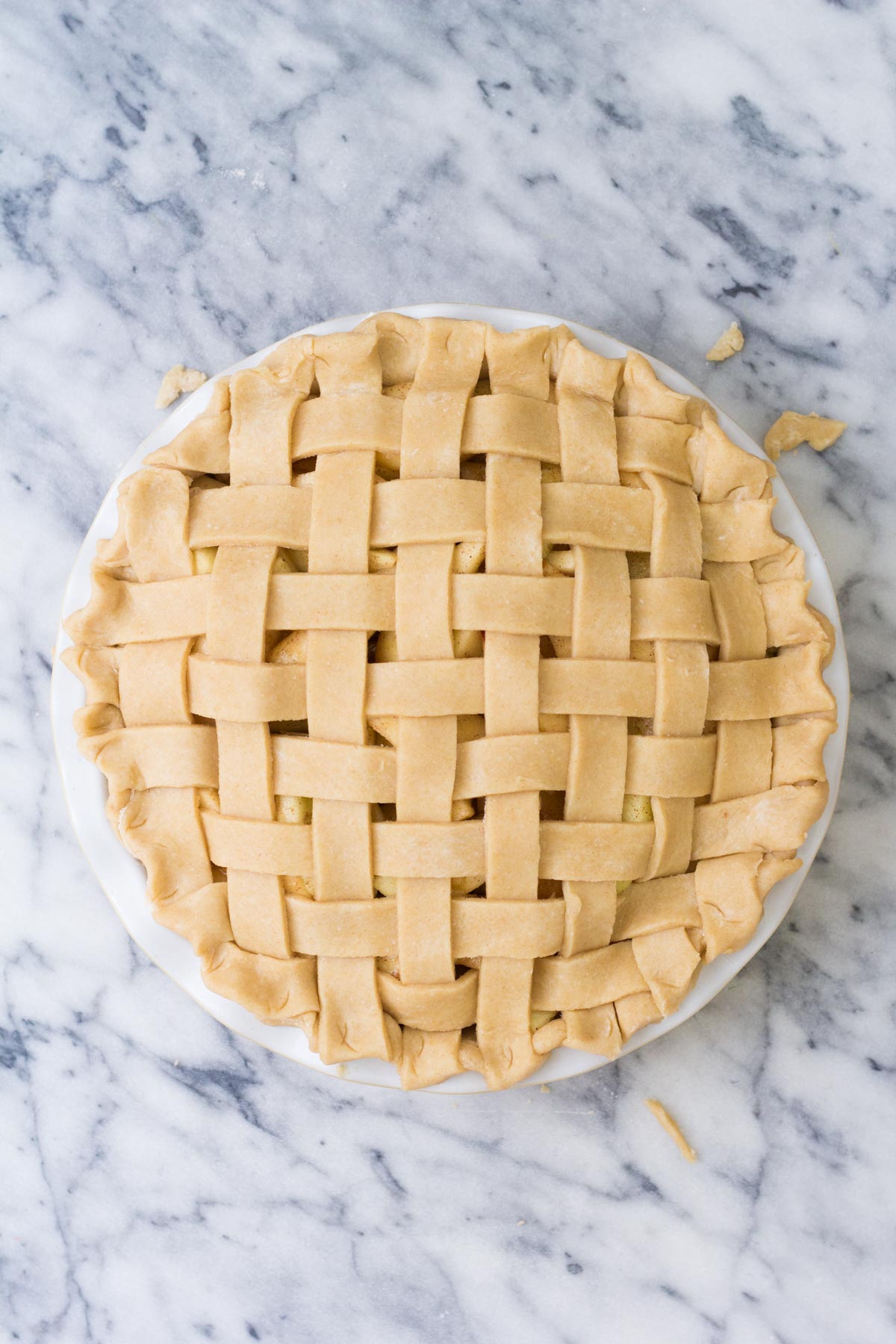 Unbaked apple pie with lattice crust.