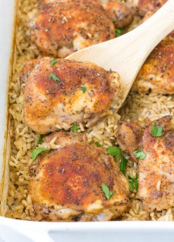 Baked Chicken and Rice in a casserole dish with a serving spoon.