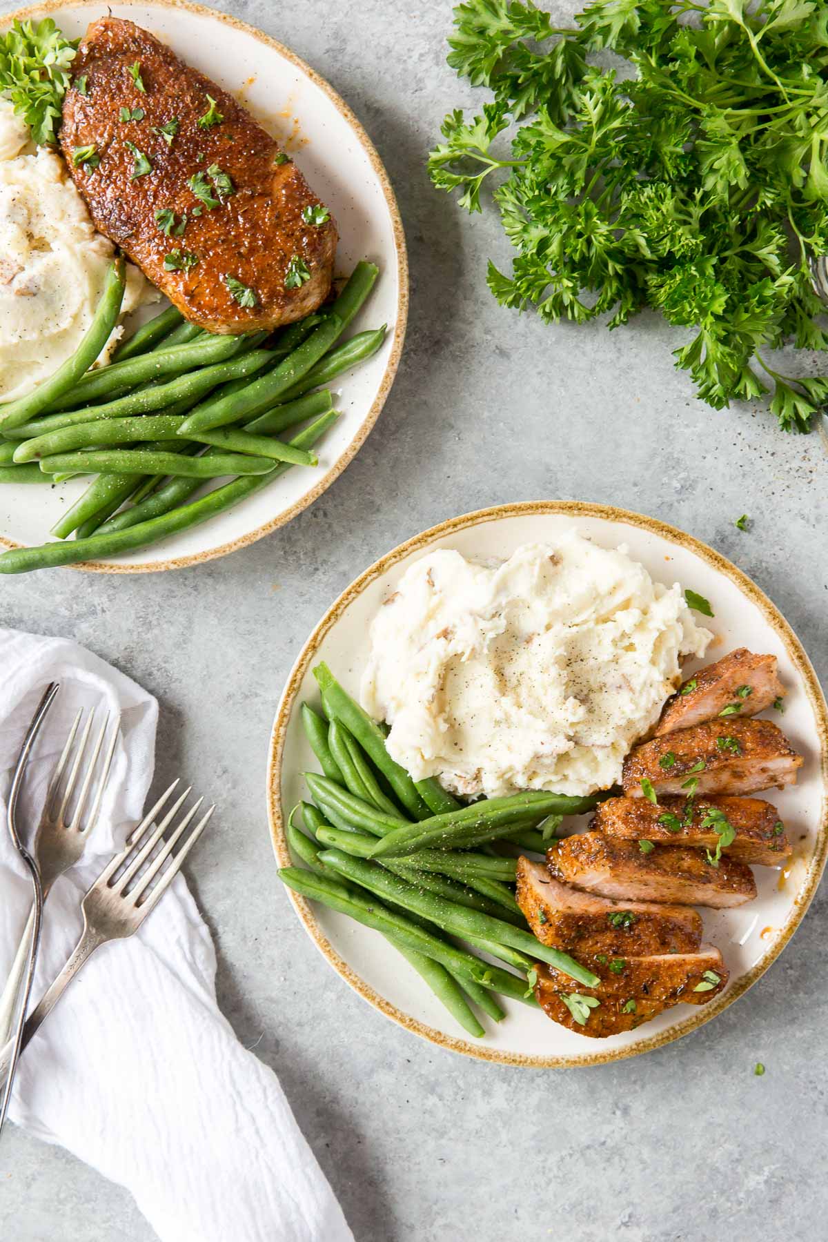 baked pork chops served with mashed potatoes and green beans