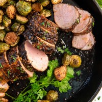 baked pork tenderloin in a cast iron skillet with brussels sprouts