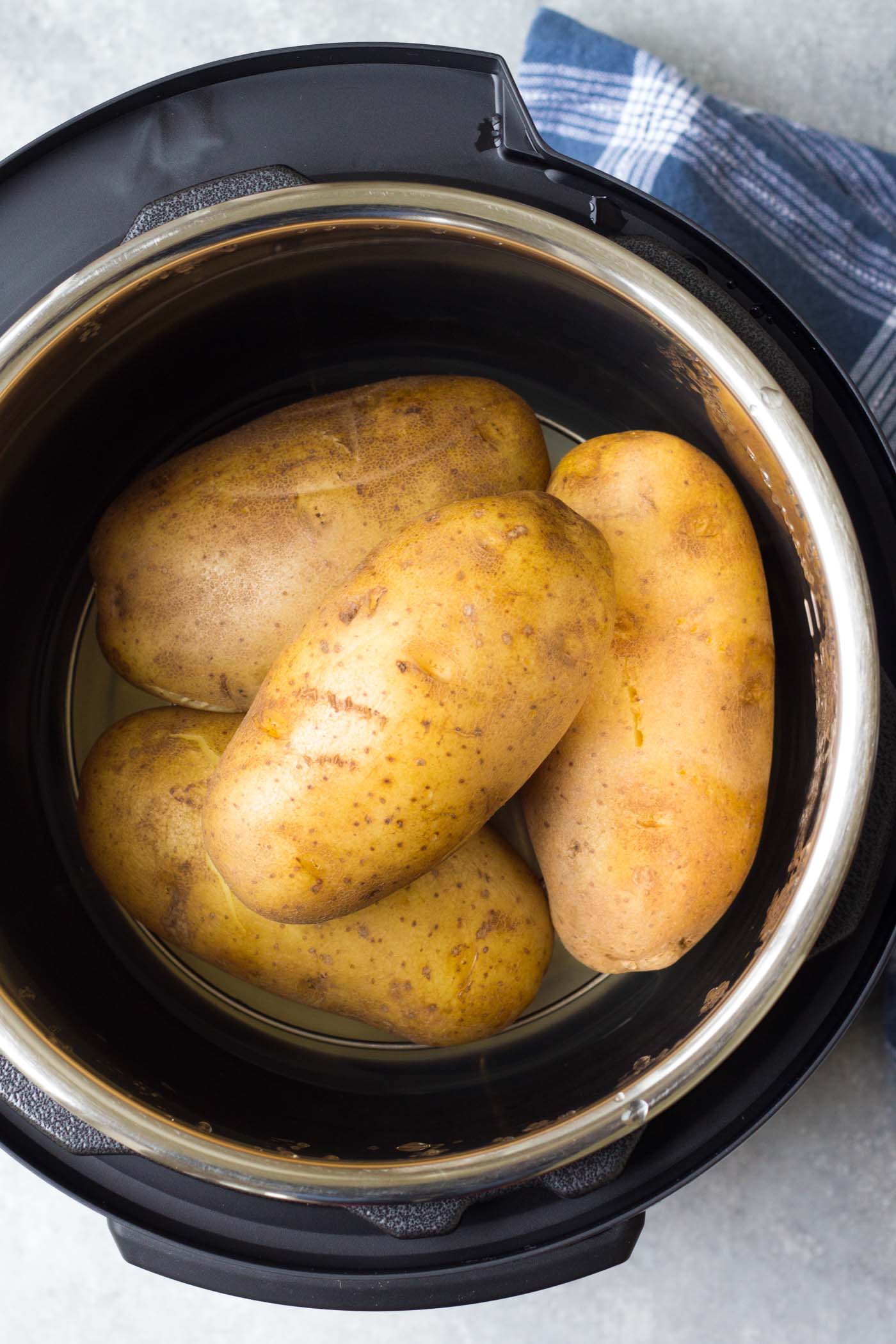 Four large baked potatoes in an instant pot.