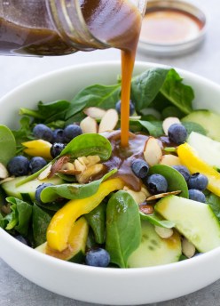 Balsamic Vinaigrette Dressing poured on a spinach salad.