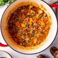 Vegetable barley soup in a Dutch oven pot.