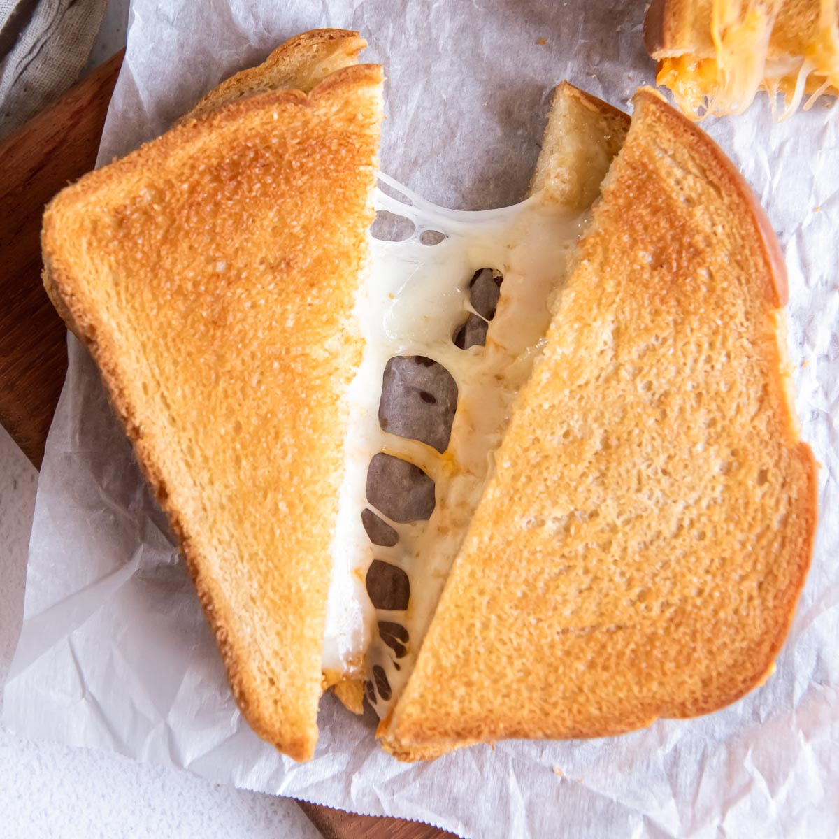 air fryer grilled cheese sandwich cut in half with melty cheese stretching
