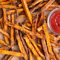 Baked sweet potato fries served with ketchup.