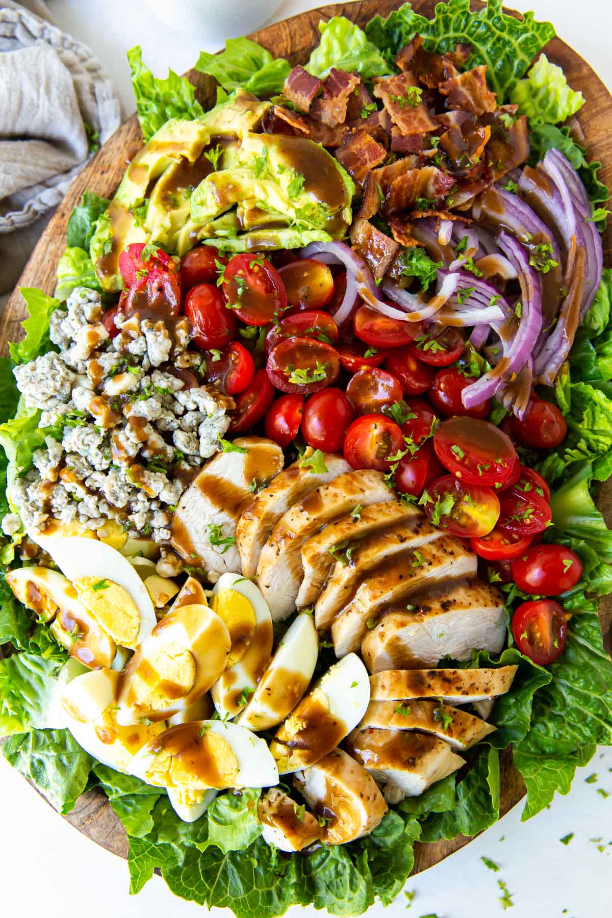 Cobb salad with balsamic dressing on large salad platter.