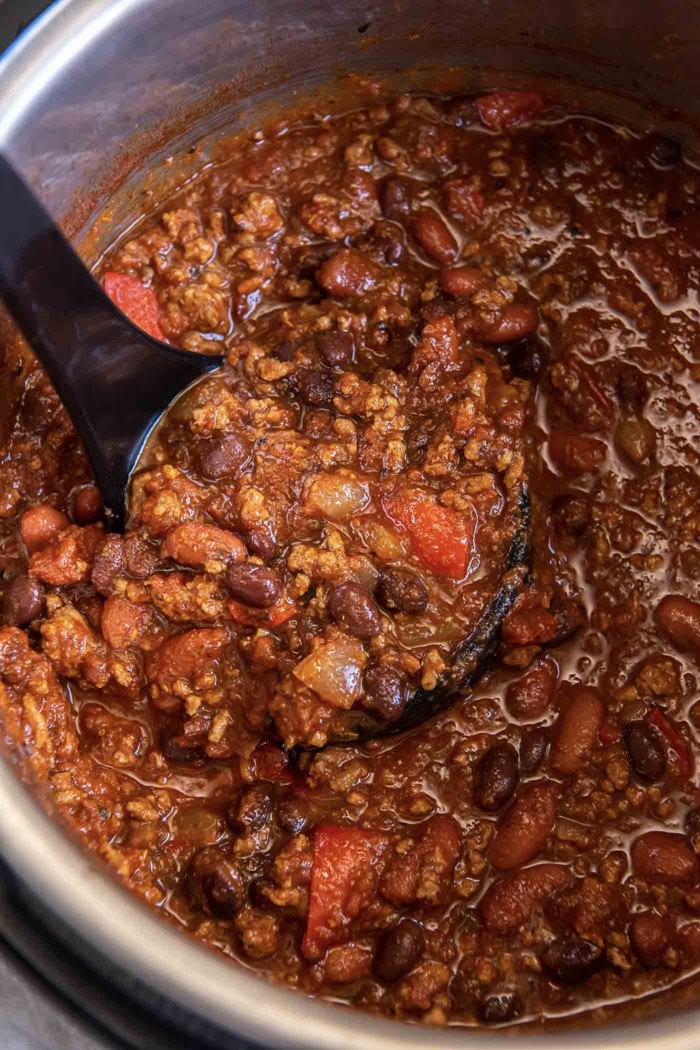 Chili on a ladle set in instant pot.