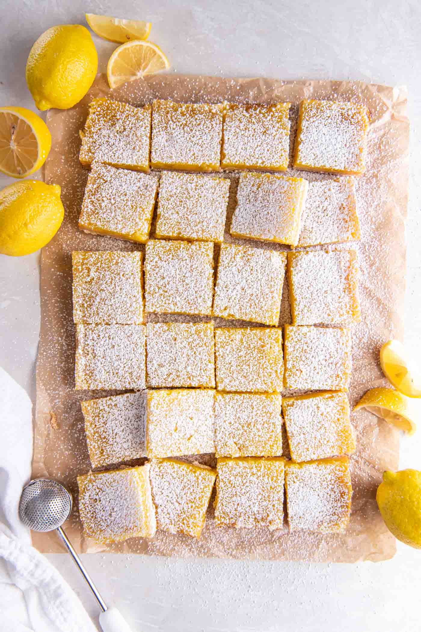 Lemon bars cut into squares and dusted with powdered sugar.