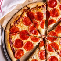 Sliced pepperoni pizza made with homemade pizza dough recipe.