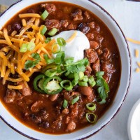Turkey chili served in a bowl with toppings.