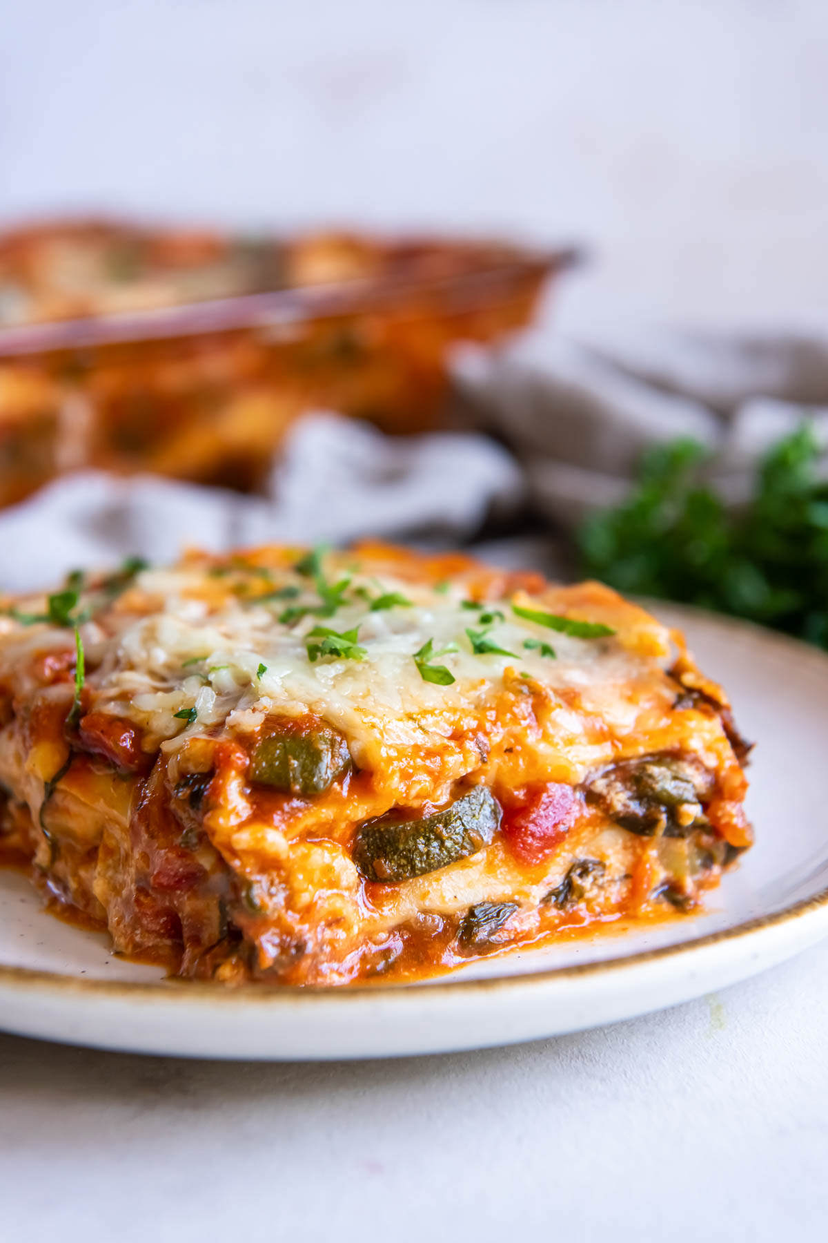 Slice of vegetable lasagna on a small plate.