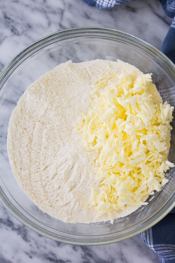 Dry ingredients with grated butter in a bowl.