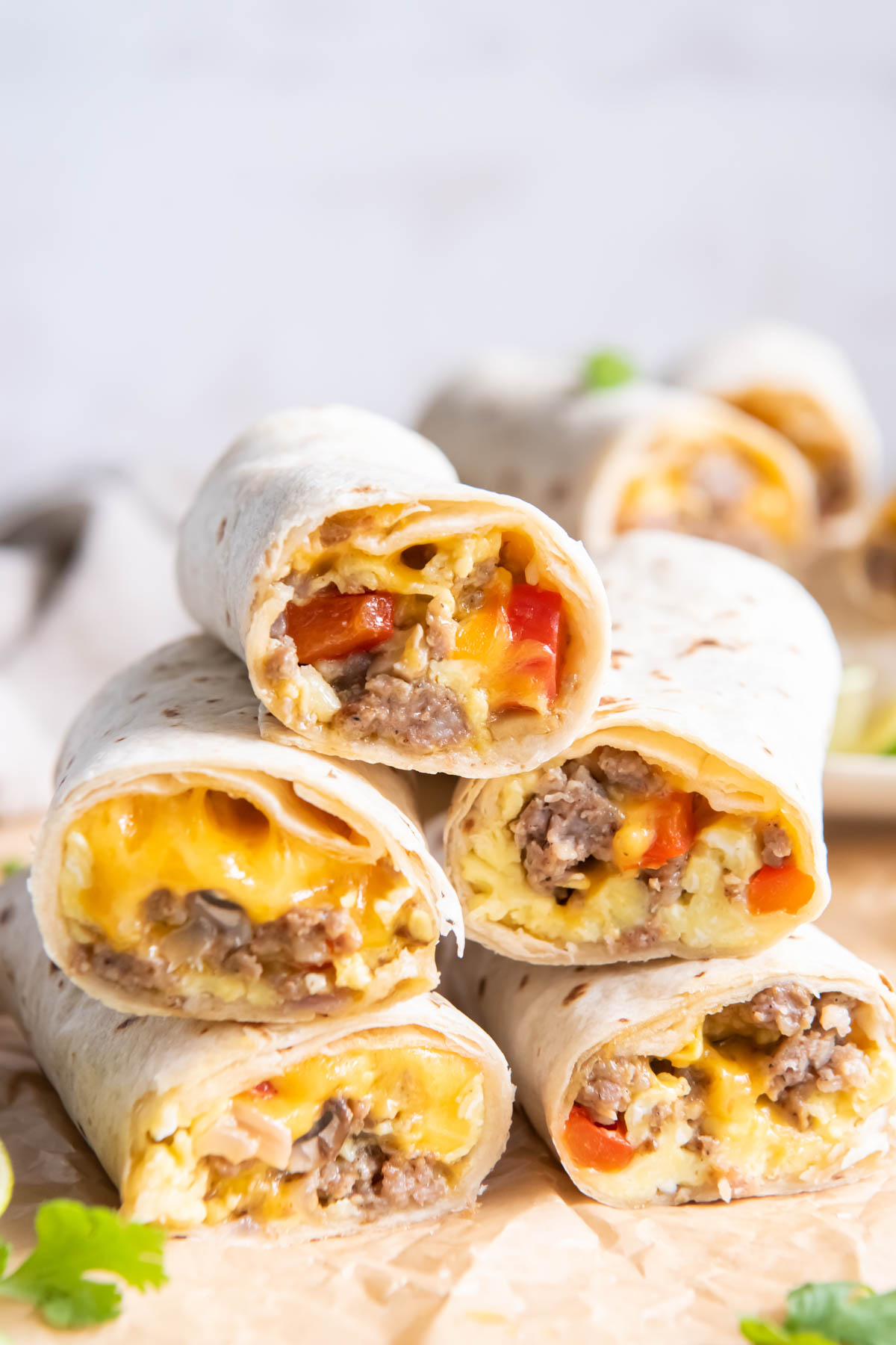 Five breakfast burrito halves stacked on top of each other.