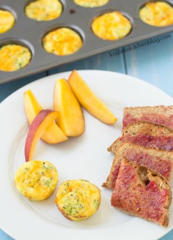 broccoli cheese frittatas on a plate with sliced peach and toast