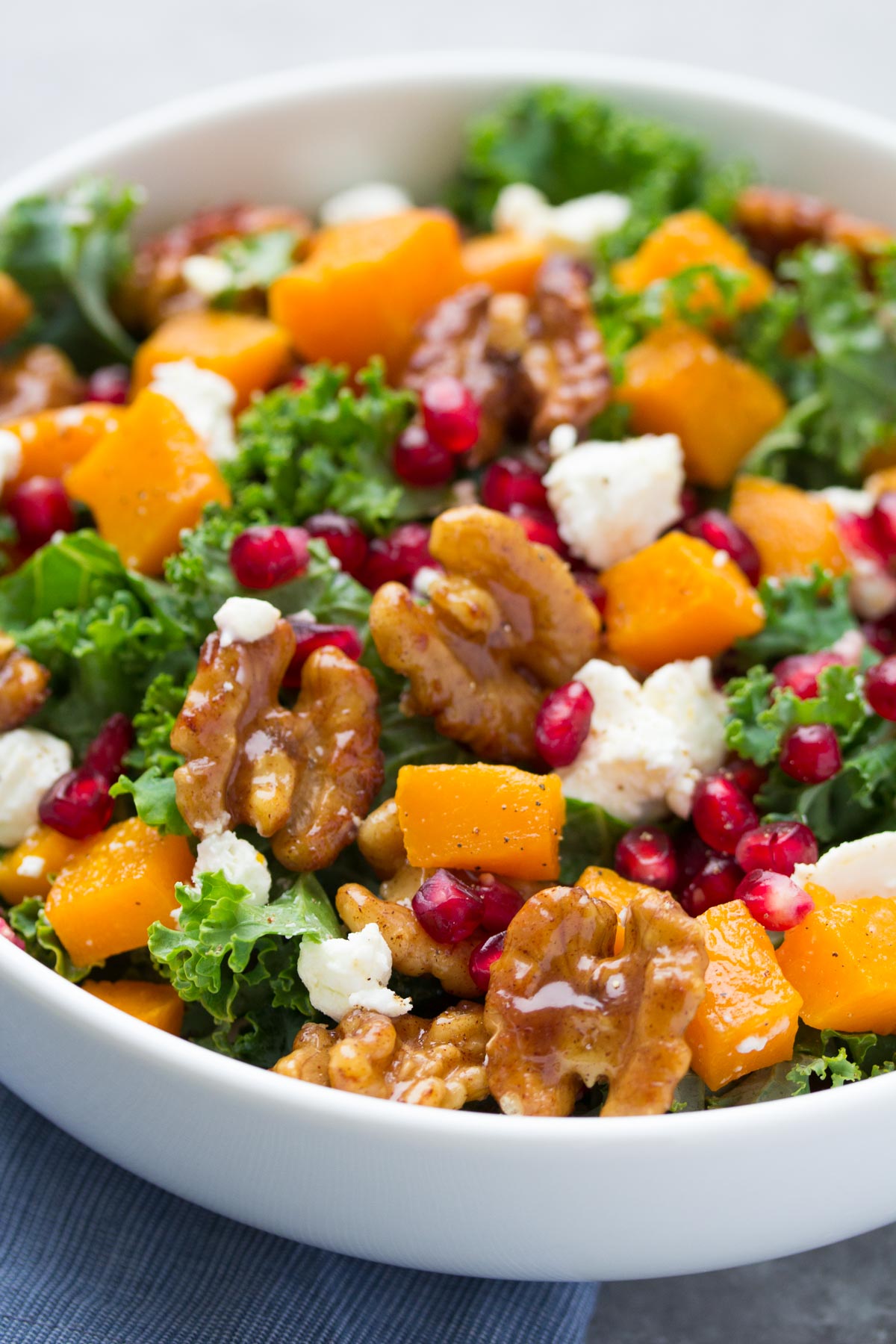 butternut squash salad with kale, candied walnuts, pomegranate seeds and goat cheese