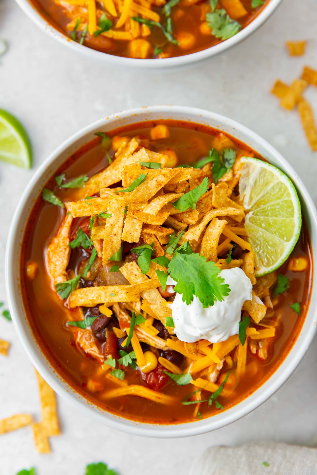 Bowl of chicken enchilada soup with toppings.
