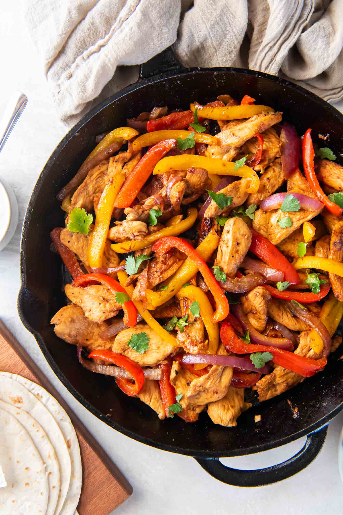 Cooked chicken fajitas in a cast iron skillet.
