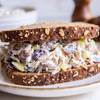Close up of chicken salad sandwich on whole wheat bread.