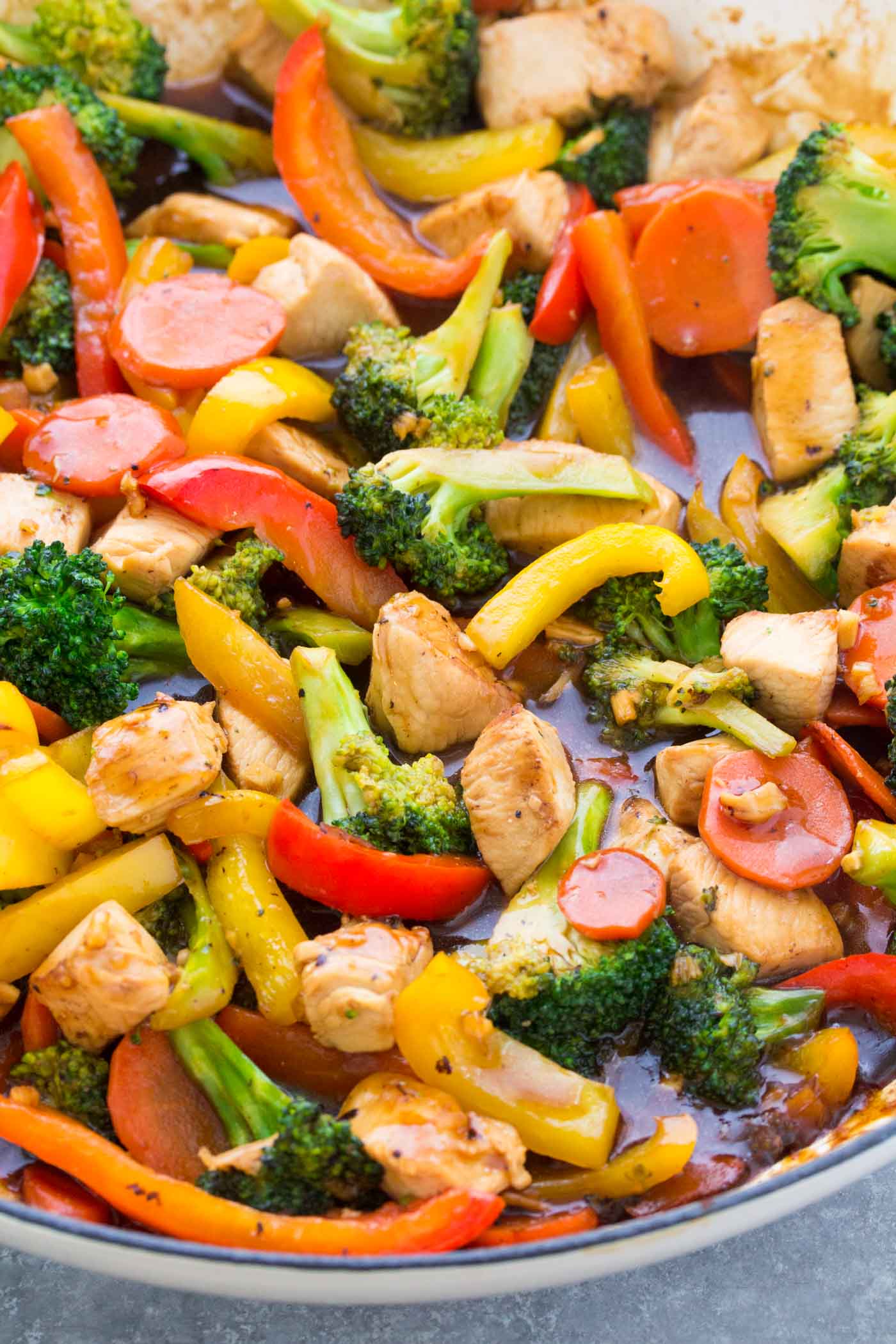 Chicken and broccoli stir fry in a skillet.