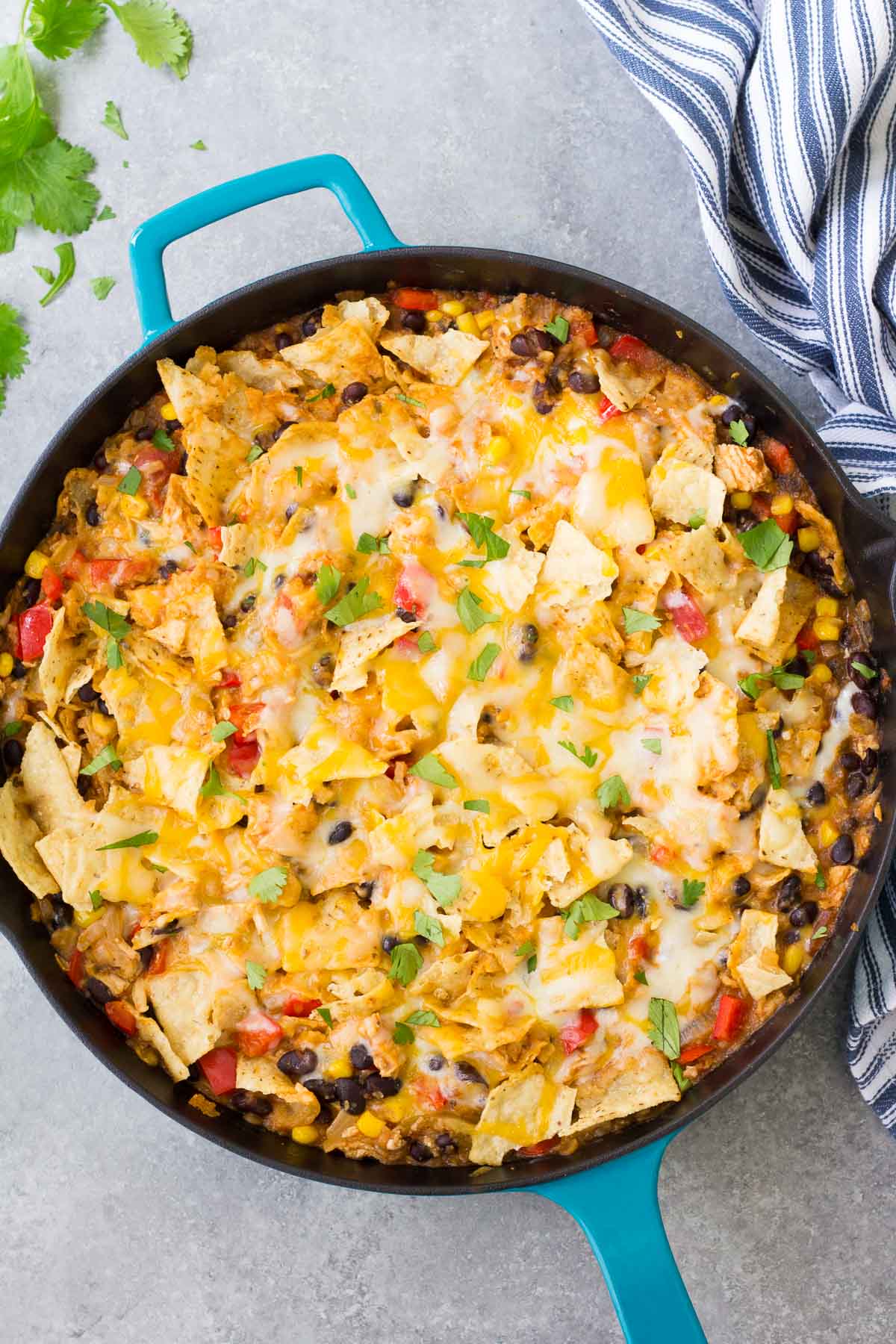 Overhead view of chicken tortilla casserole in a turquoise skillet.