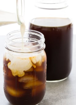 How to make cold brew coffee. Pouring cream into iced coffee.