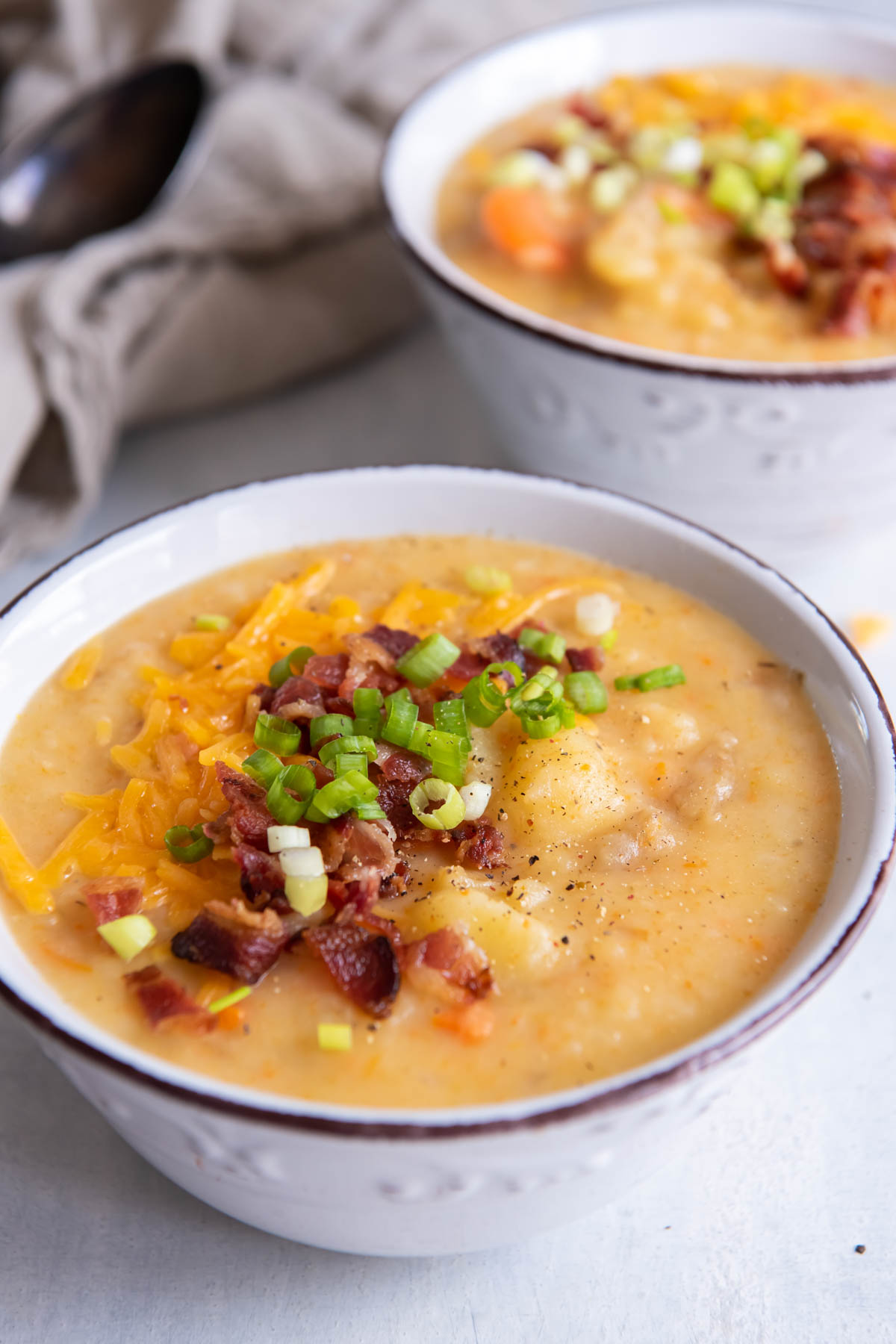 Bowl of instant pot potato soup with toppings.