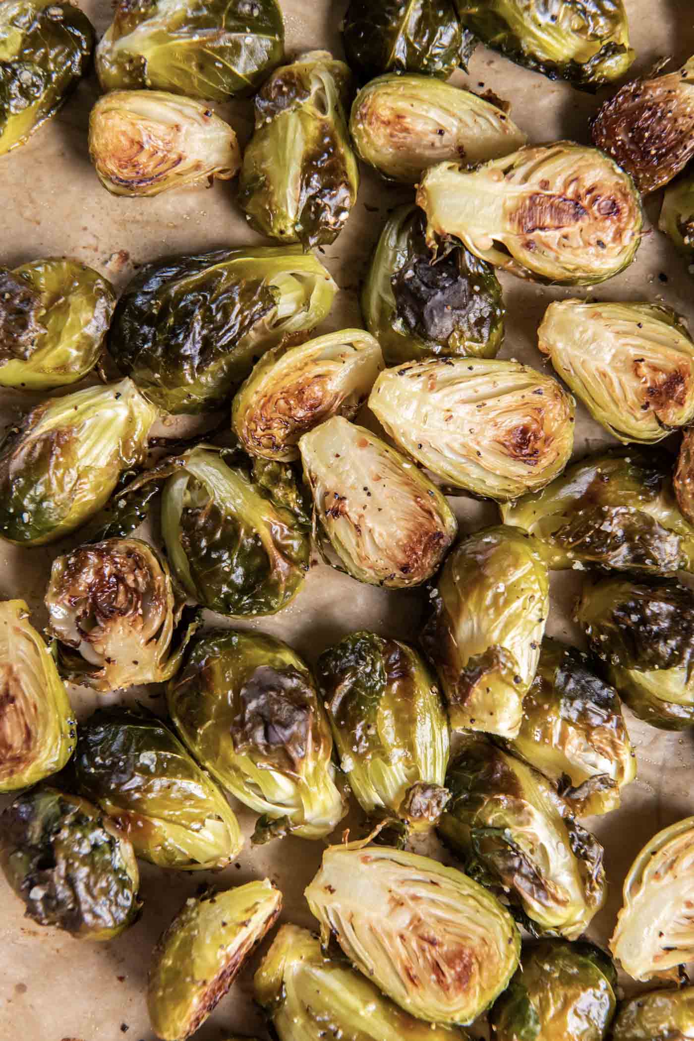 Close up of baked Brussels sprouts on baking sheet.