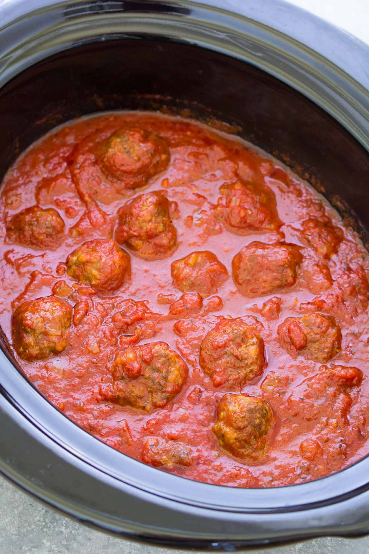 Meatballs and marinara sauce in crockpot.