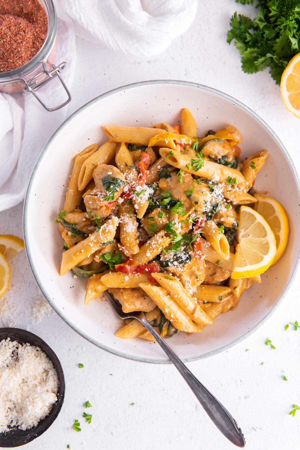 Cajun chicken pasta served in a bowl with grated Parmesan.
