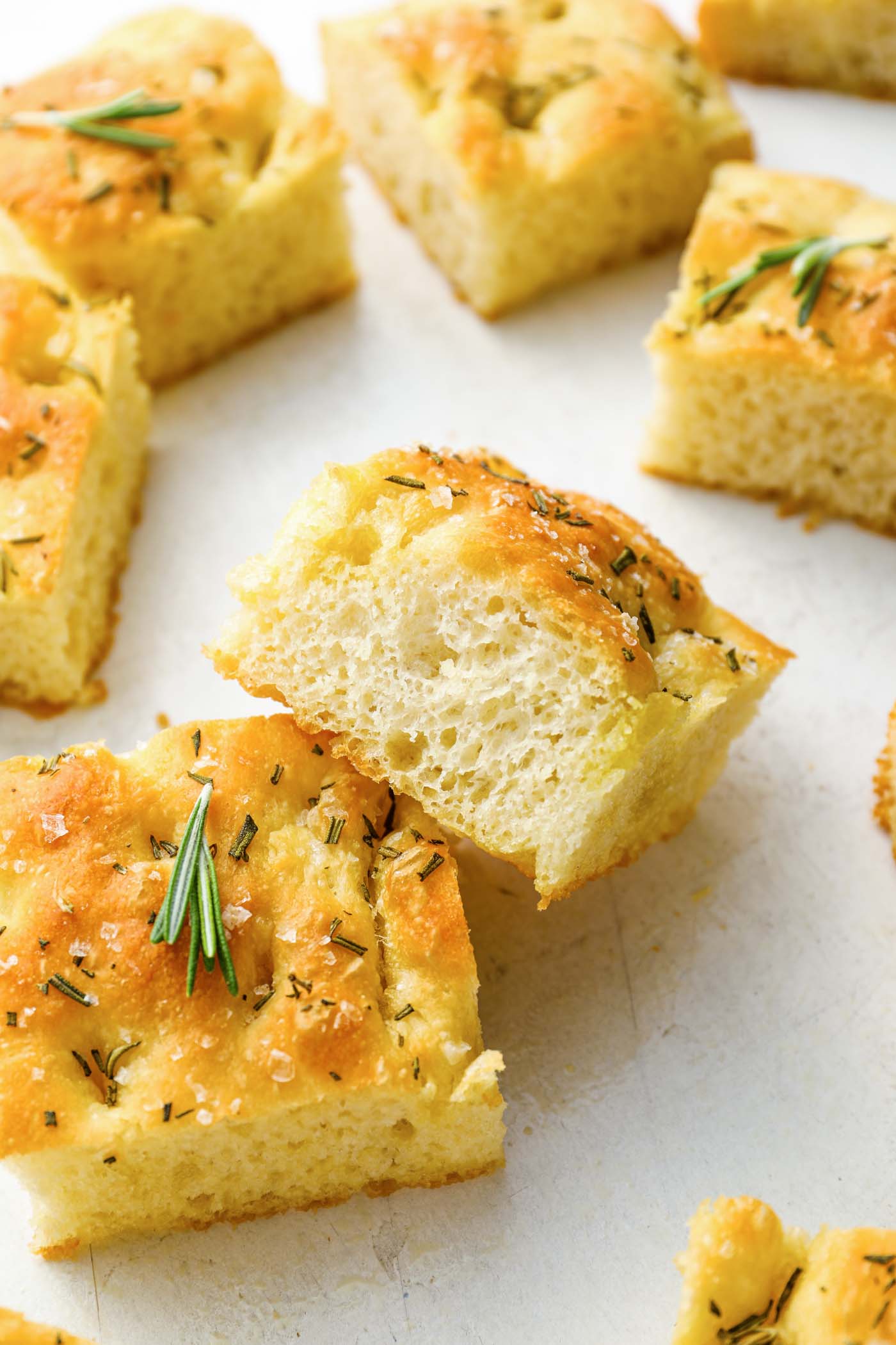 Cut slices of focaccia with one slice resting on another to show the airy texture.