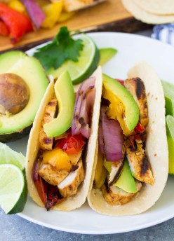 two chicken fajitas served with avocado