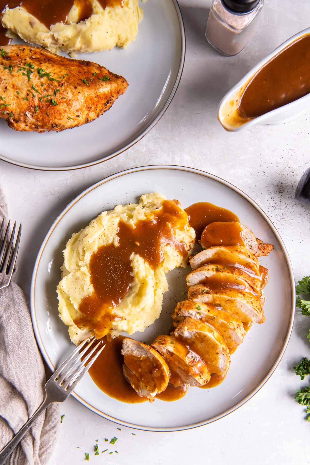 Juicy instant pot chicken breasts served with gravy and mashed potatoes.
