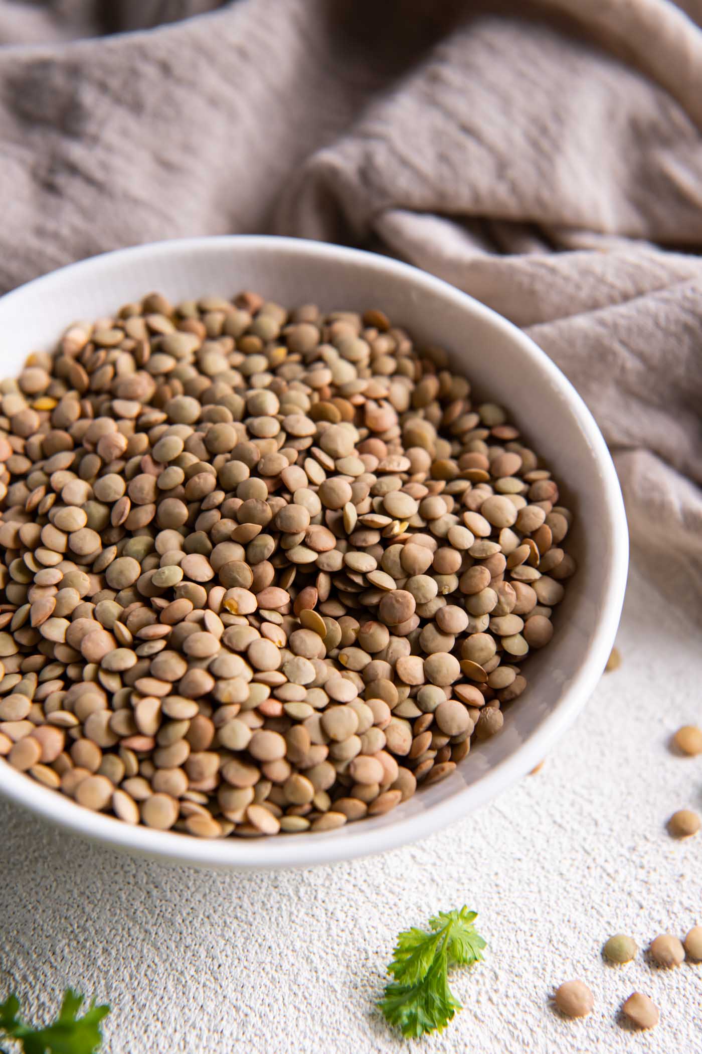 Dry green lentils in a bowl.