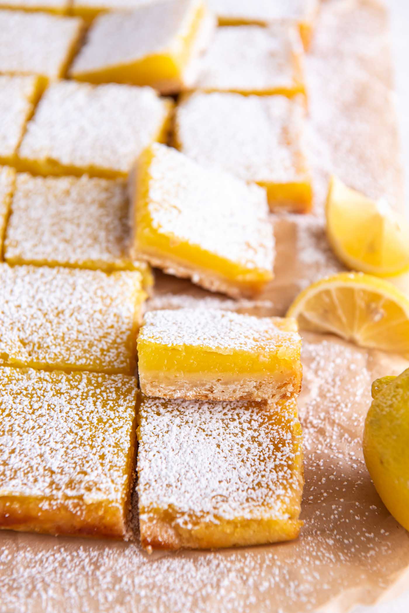 Lemon bars cut into squares and dusted with powdered sugar.