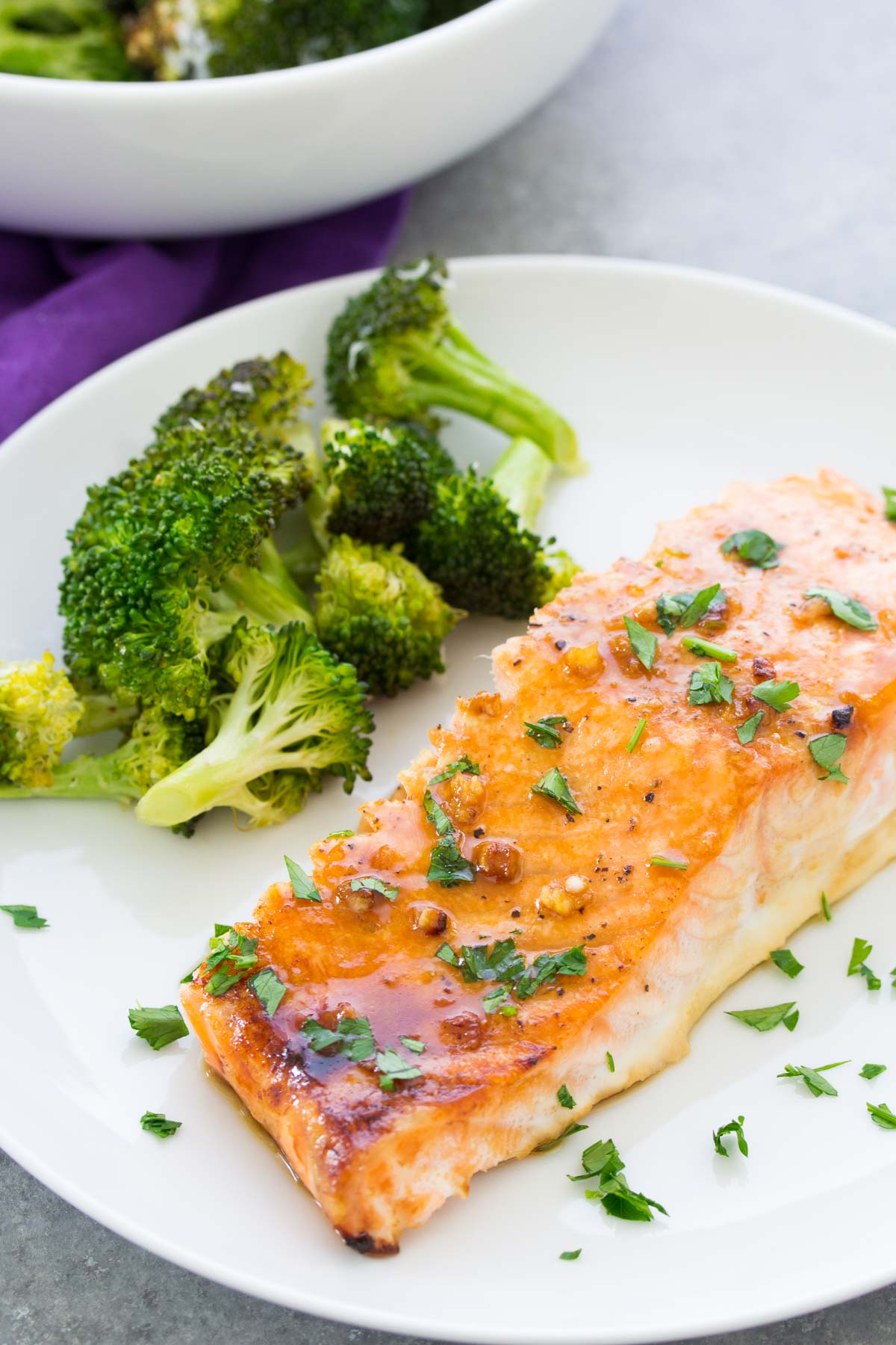 Baked salmon with honey garlic sauce on a plate with broccoli. Easy salmon recipe.