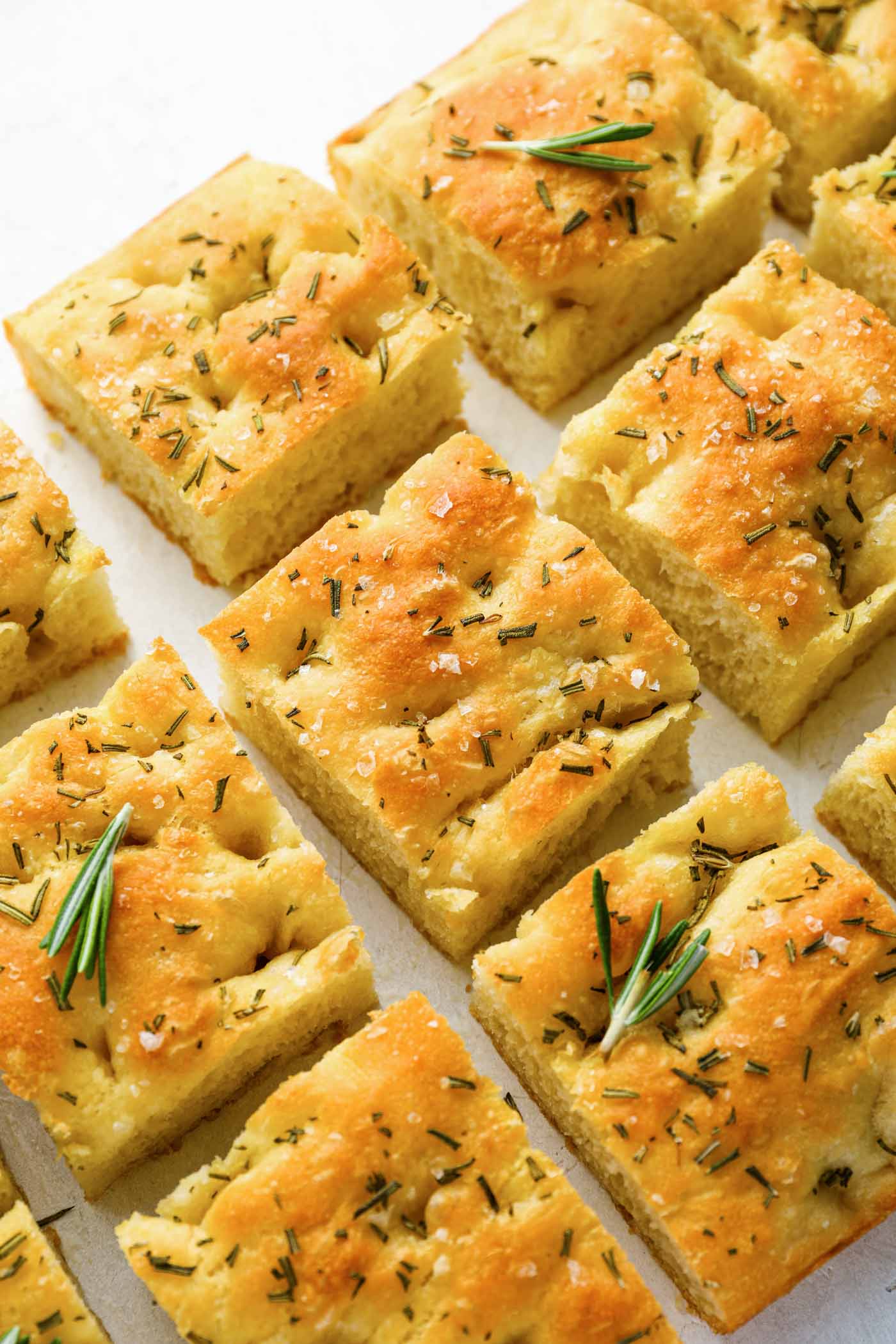 Slices of focaccia bread with fresh rosemary garnish.
