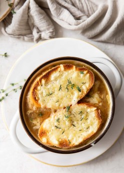 french onion soup in a bowl with two cheese toasts on top
