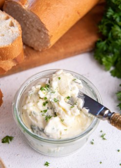 garlic butter in a small dish with a knife
