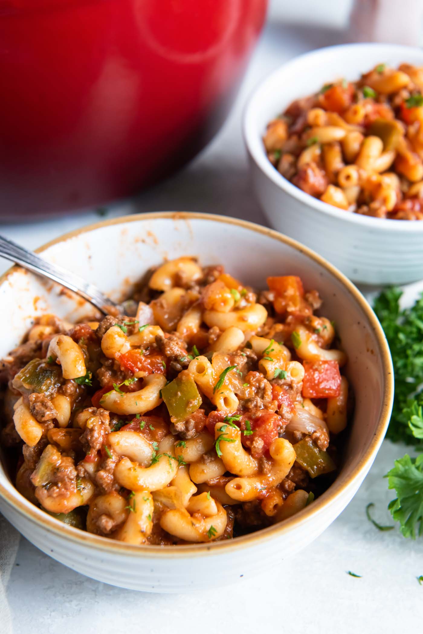 Goulash served in a bowl with a spoon.