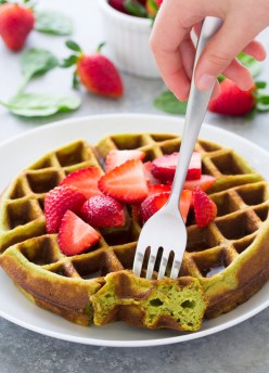 These Blender Green Smoothie Waffles are a fun way to get kids to eat their greens! The waffle batter is mixed up in a blender so they are really easy to make. The waffles turn out crisp on the outside with soft insides. The waffles have a hint of green smoothie flavor, with a little coconut and banana mixed in!