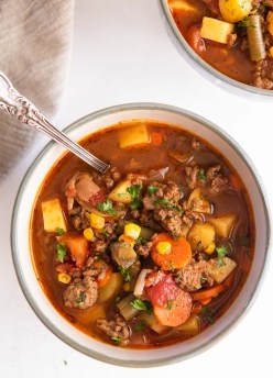 Bowl of hamburger soup with a spoon.
