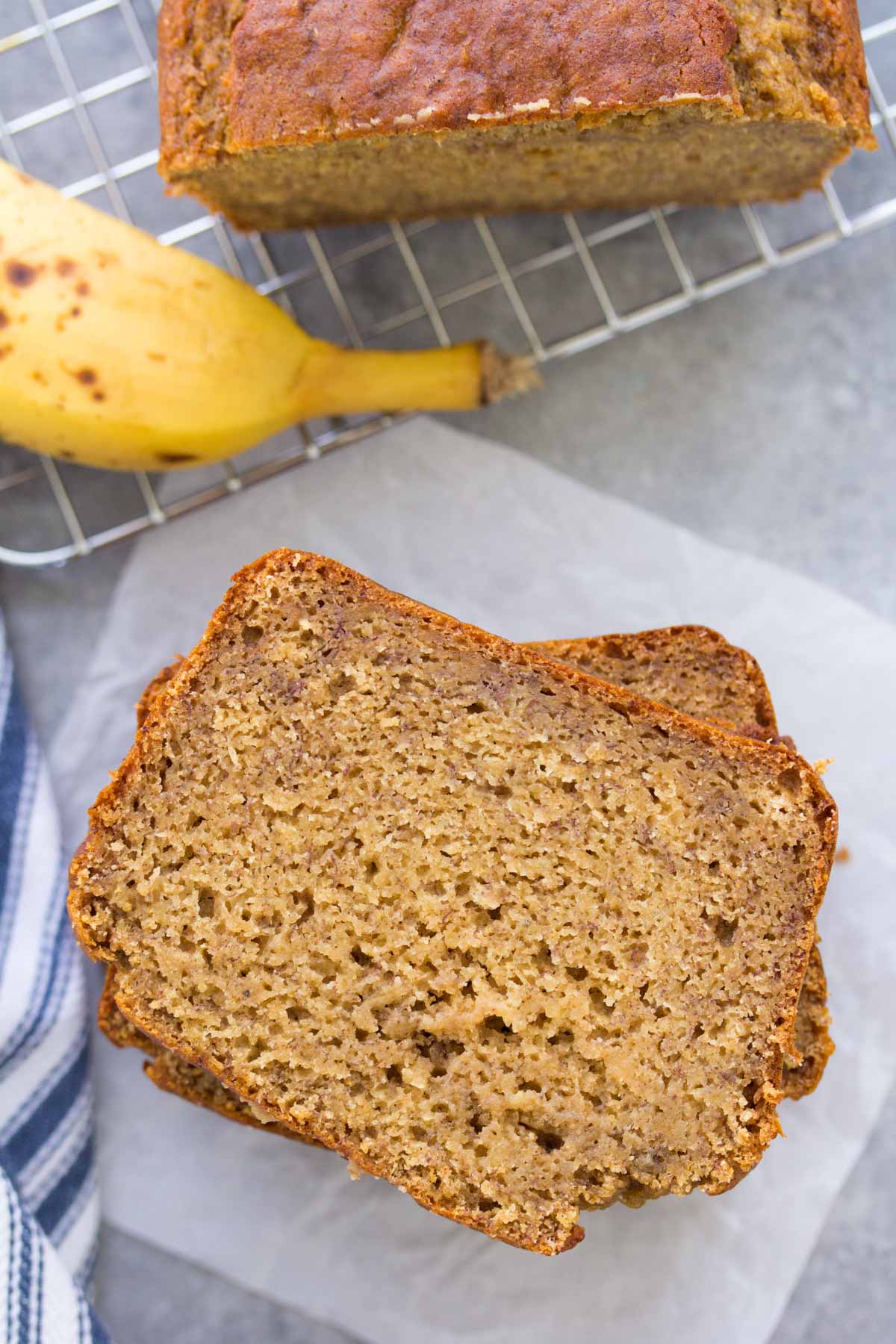 Slices of healthy banana bread stacked on top of each other, showing the soft, moist texture.