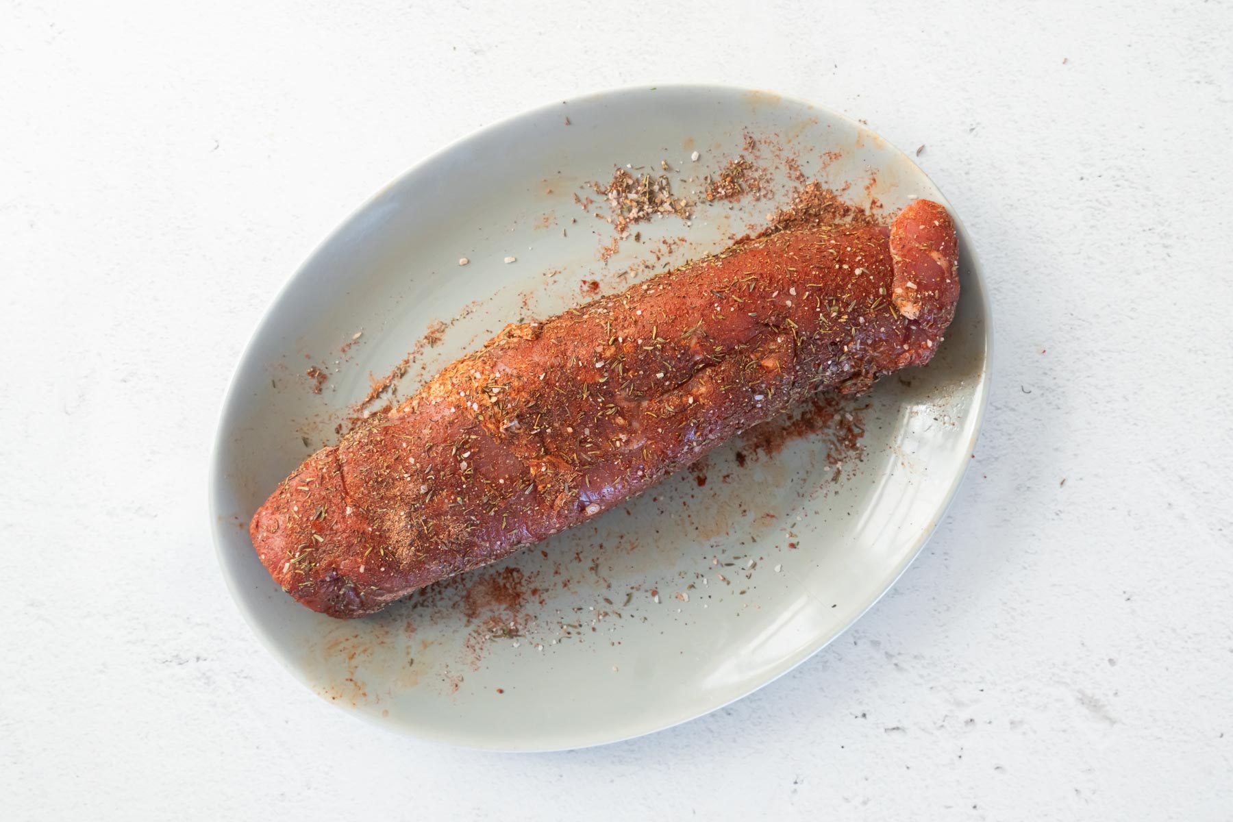 raw pork tenderloin rubbed with spices
