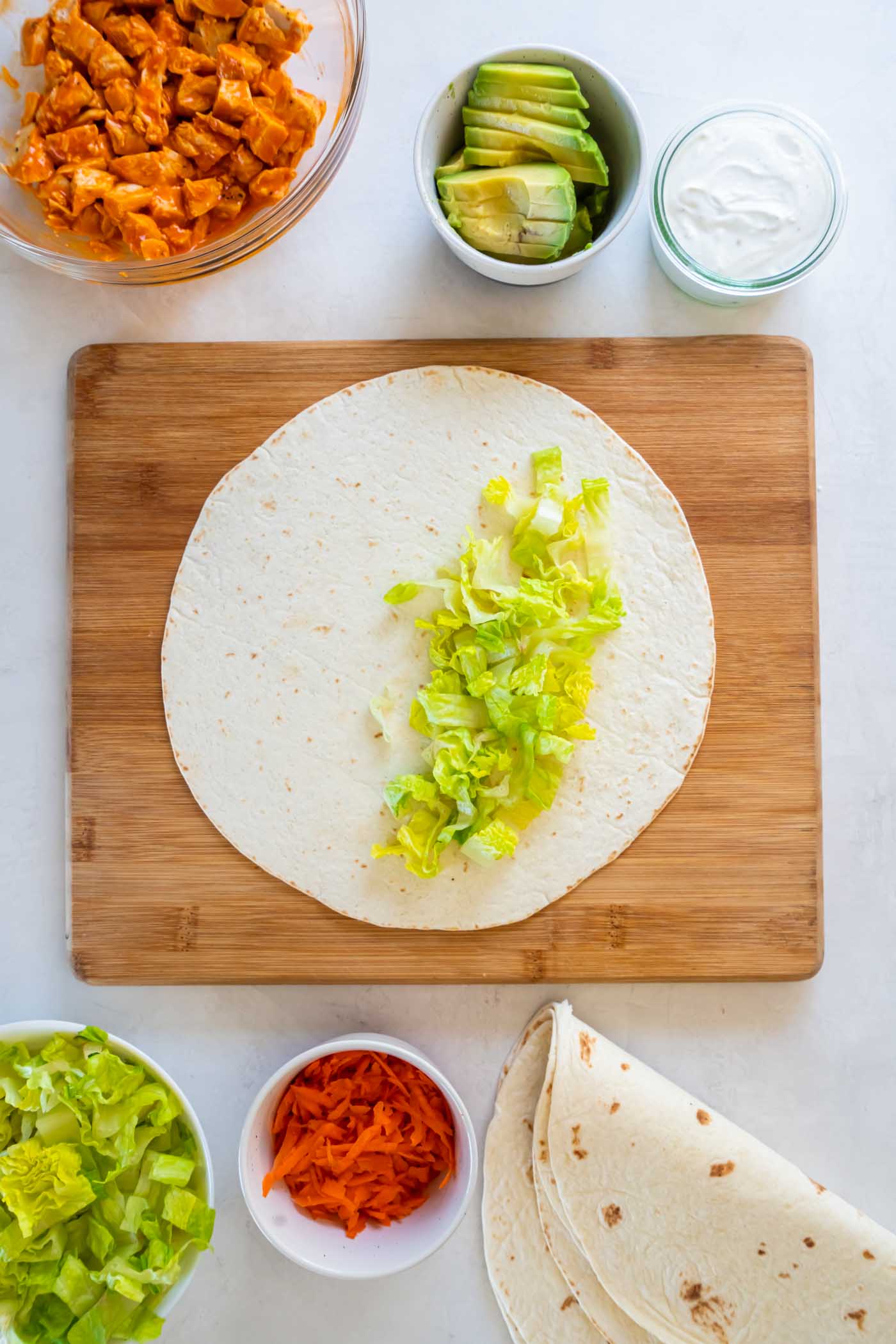 Tortilla with chopped romaine lettuce down the center.