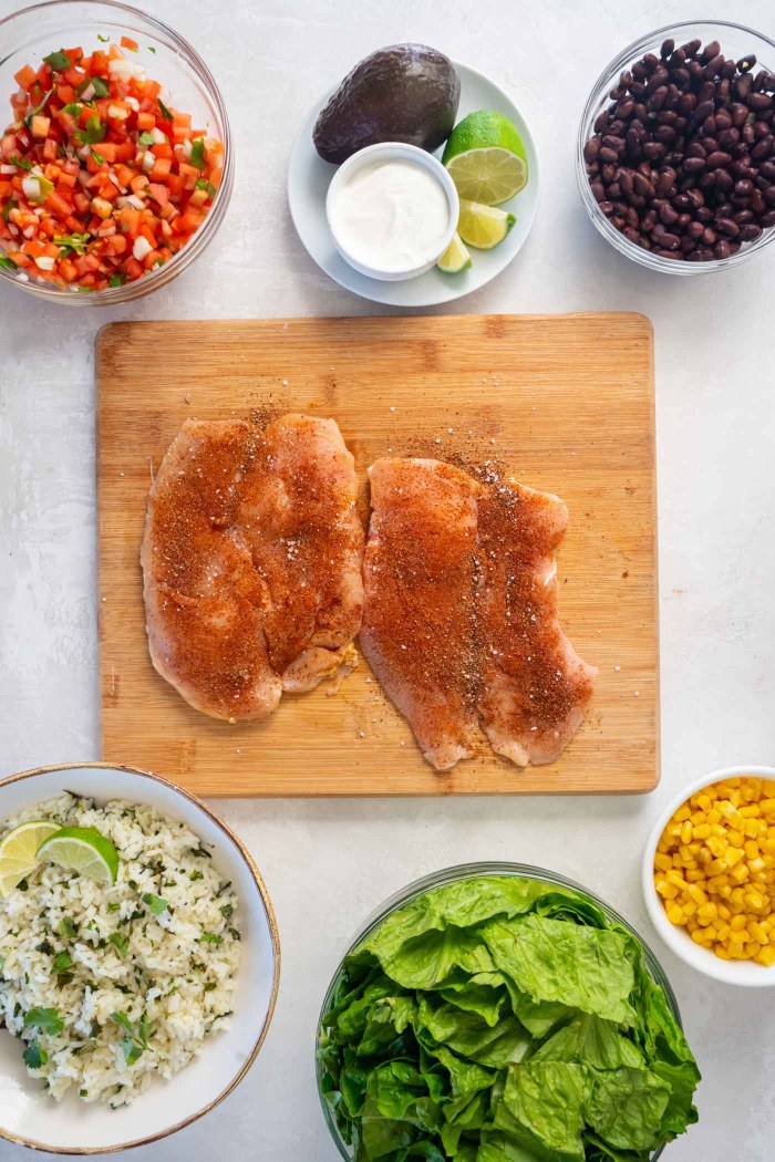 Seasonings rubbed onto raw chicken breasts that have been pounded thin.