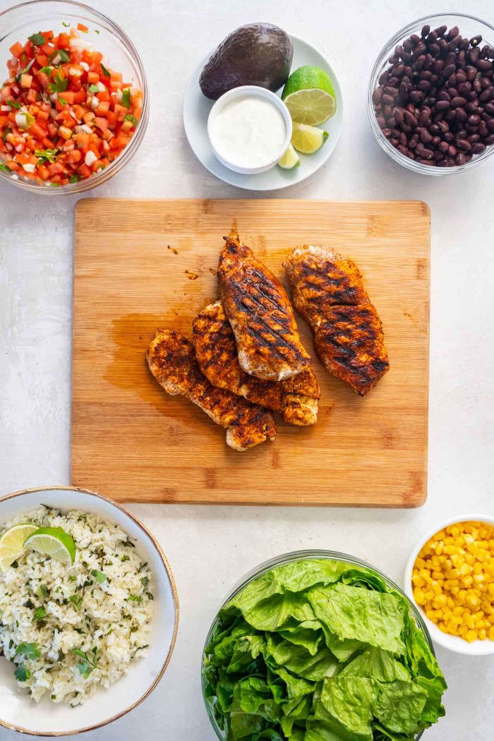 Grilled chicken resting on a cutting board.