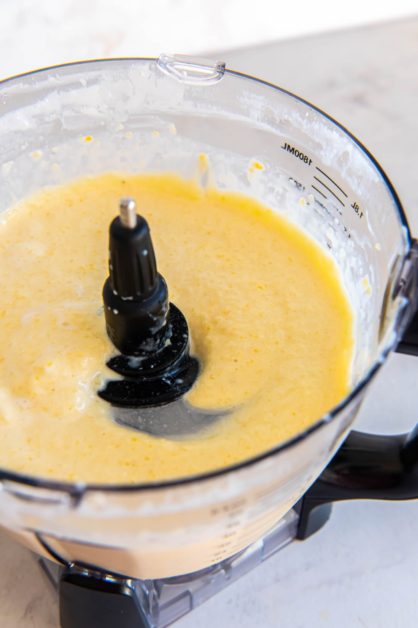 Blended mango smoothie in a blender.